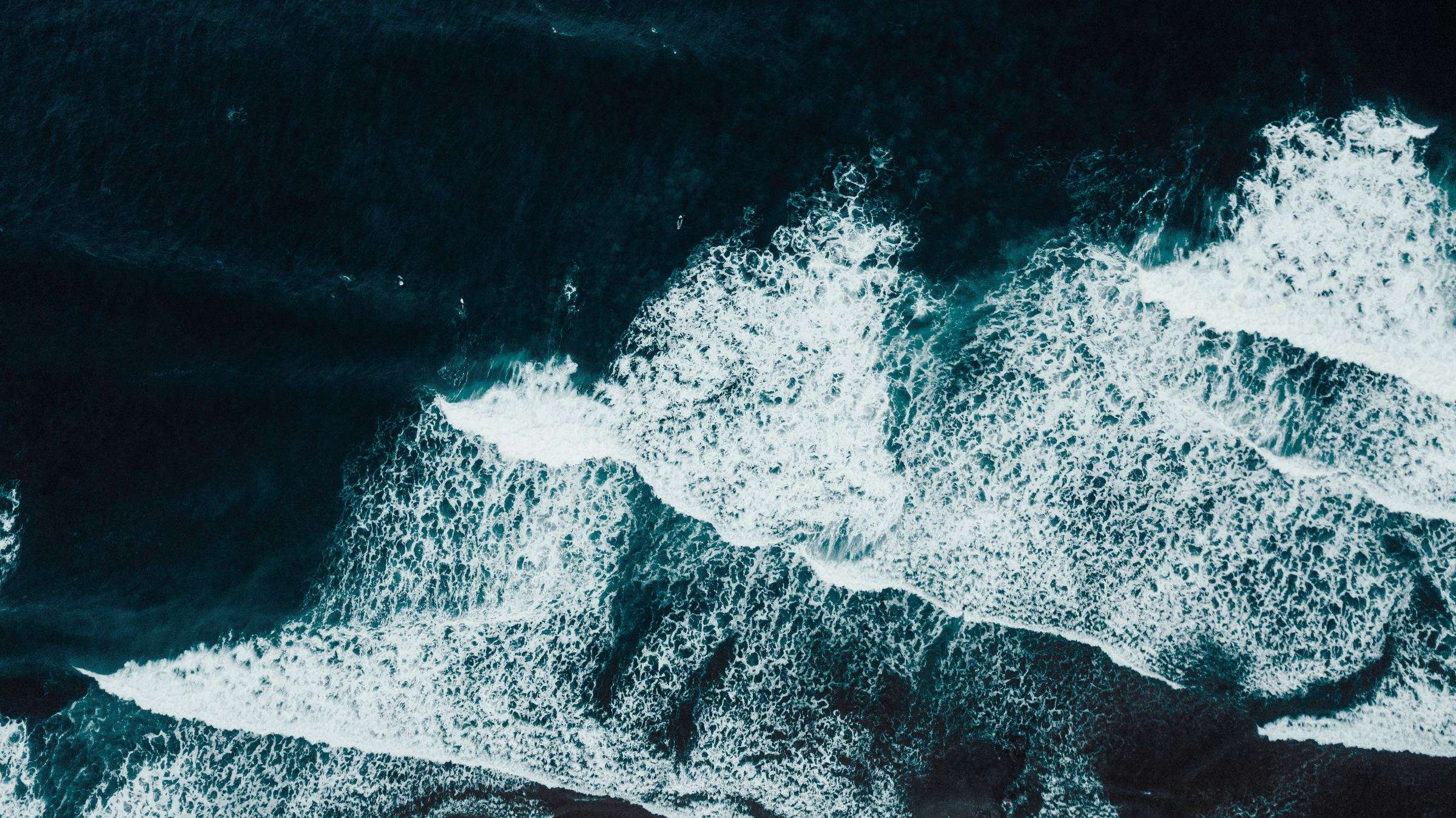 Aerial view of dark open ocean at dawn