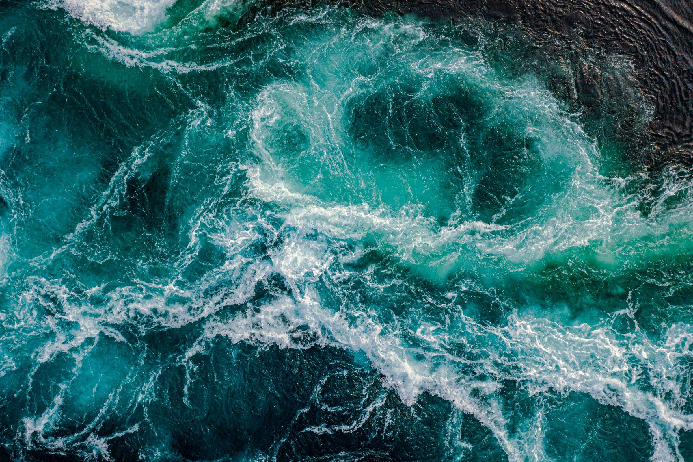 Aerial view of foam patterns on ocean surface